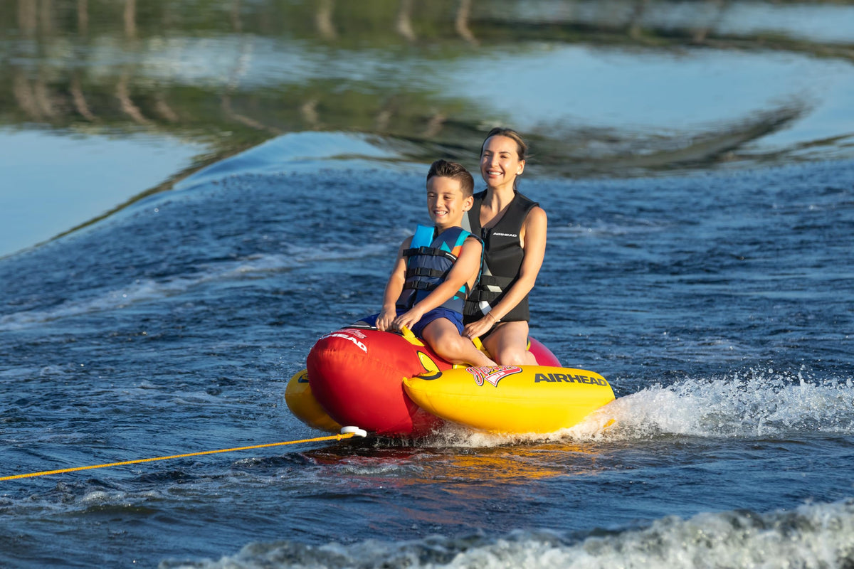 Airhead Hot Dog Towable Tube for Boating, 1-5 Rider Inflatable Boat Tube for Water Tubing, Full Nylon Cover, EVA Padding, Foam Padded Handles w/Neoprene Knuckle Guard, Speed Safety Valve